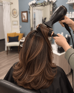 Stylist blow drying freshly highlighted hair at Metropolitan Hair Boutique