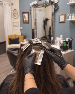 Foils being placed through the top section of hair at Metropolitan Hair Boutique