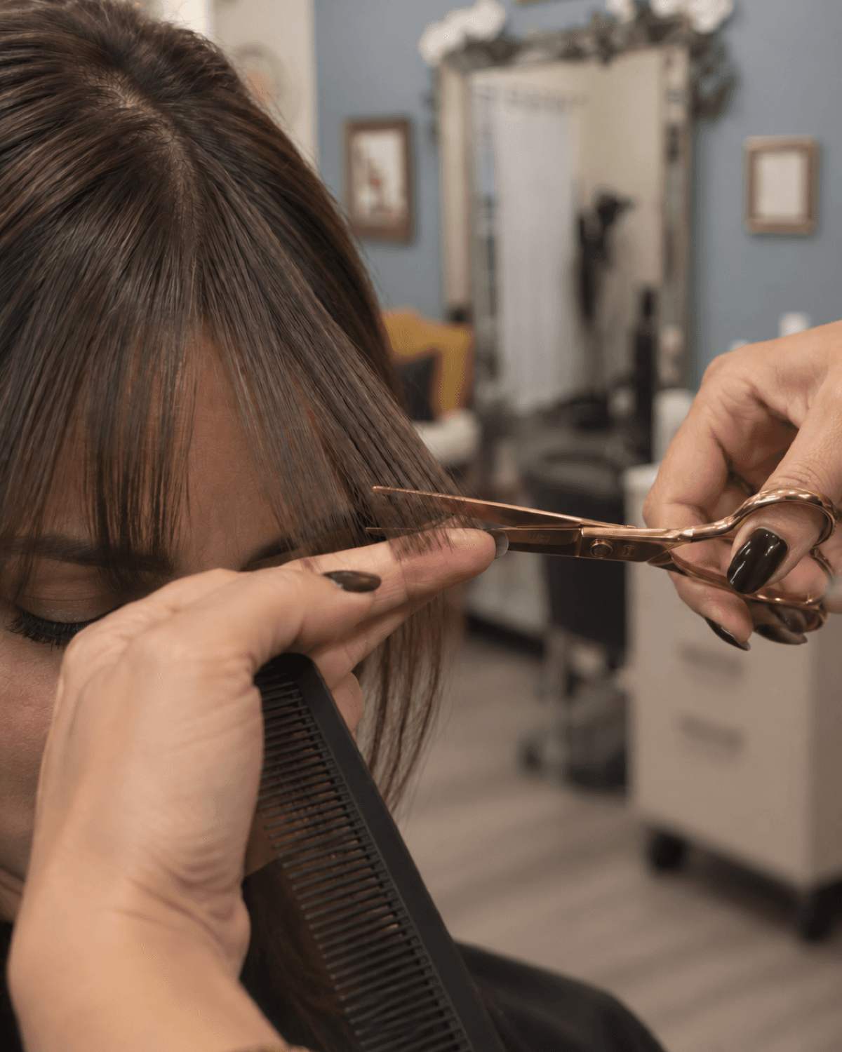 Close-up of scissors trimming a small section of bangs